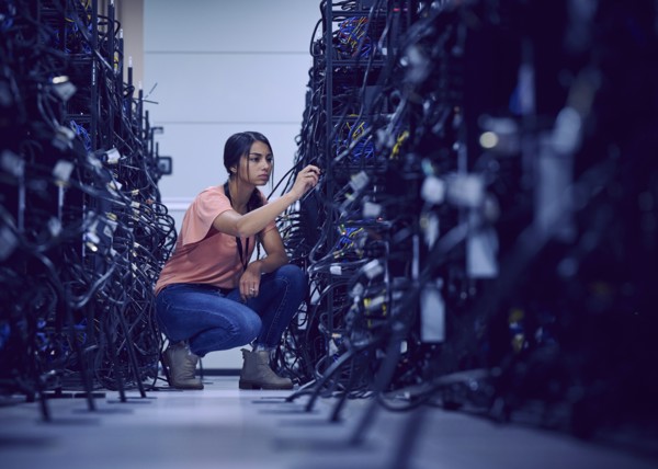 Female technician working in server room