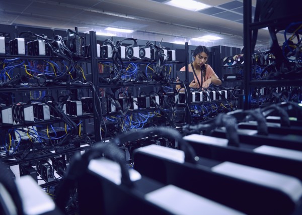 Female technician working in server room