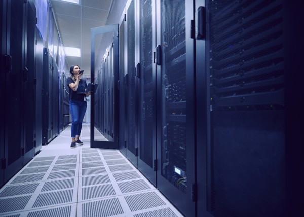 Female technician working in server room