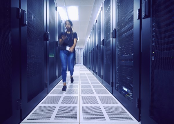 Female technician walking in server room