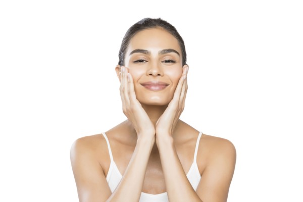 Portrait of smiling young woman doing facial massage