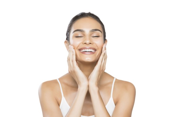 Portrait of young woman with closed eyes doing facial massage