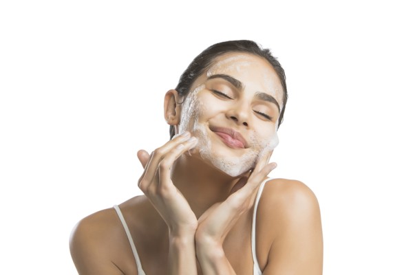 Portrait of young woman enjoying washing face