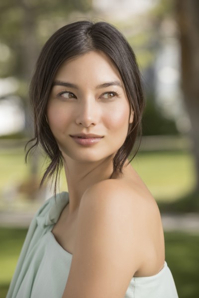 Portrait of beautiful woman looking away in park