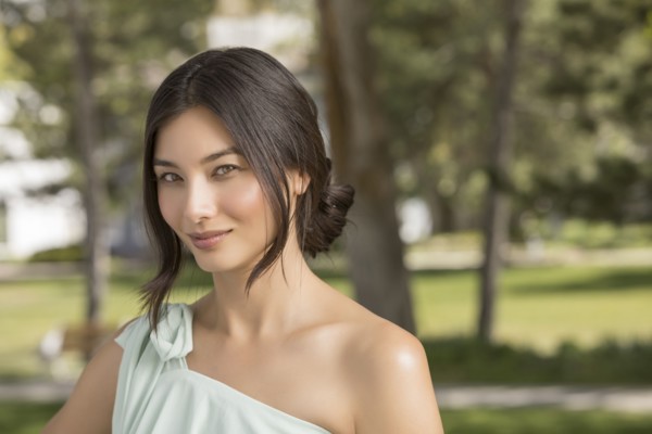 Portrait of beautiful woman looking at camera in park
