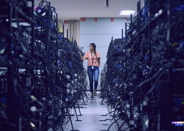 Female technician working in server room