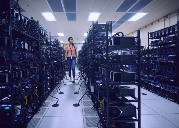 Female technician working in server room
