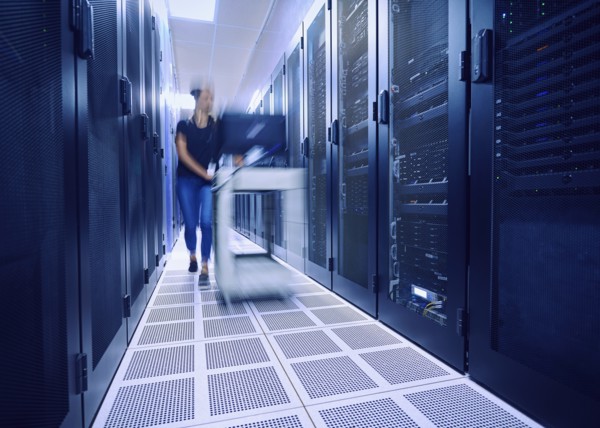 Female technician pushing cart in server room