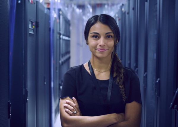 Portrait of smiling female technician in server room
