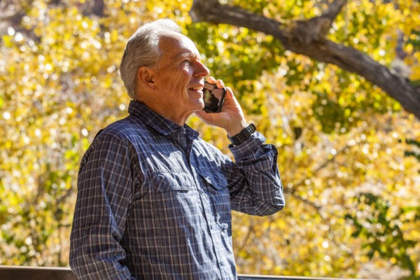 Senior man with smartphone in Zion National Park