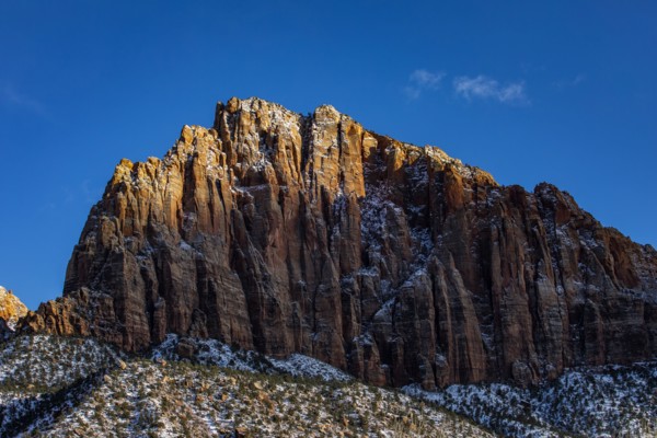 Scenic view of mountain peak against blue sky
