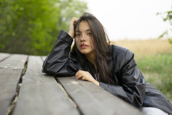 Portrait of teenage girl leaning on picnic table