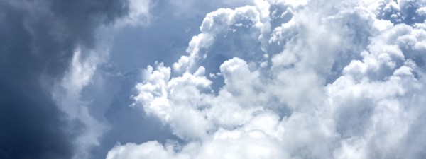Puffy white and blue clouds on sky