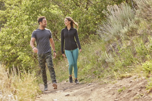 Mid adult couple hiking in forest