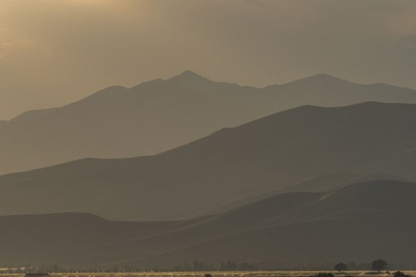 Mountain landscape in fog at sunset