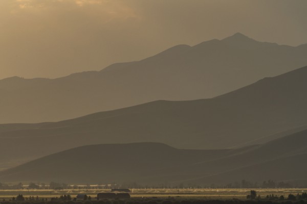 Mountain landscape in fog at sunset