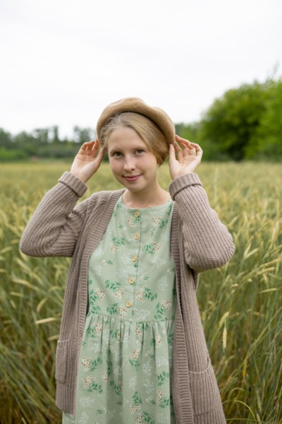 Portrait of young woman wearing beret standing in wheat field