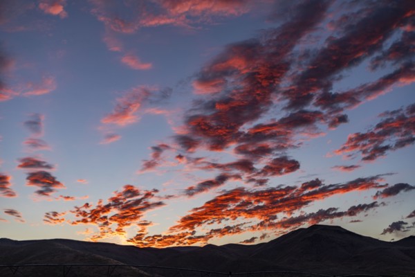 Silhouette of mountains with sunrise in background