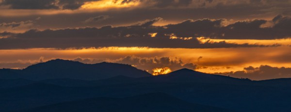 Beautiful sunset over silhouettes of mountains