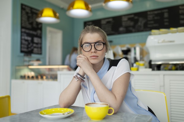 Portrait of serious woman sitting in cafe