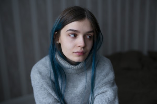 Portrait of serious woman in gray sweater