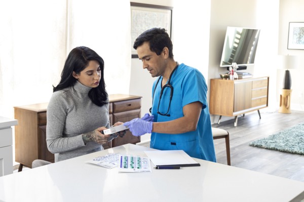 Patient consulting medical records with nurse