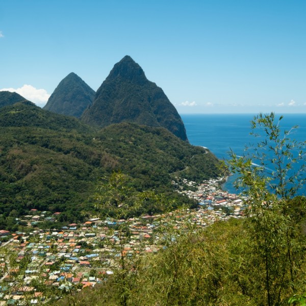 Town in hilly landscape with sea in background, Soufriere, West Indies, St Lucia