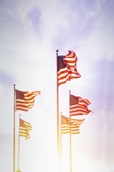 American flags blowing on wind against sky at sunset, Jersey City, New Jersey, USA