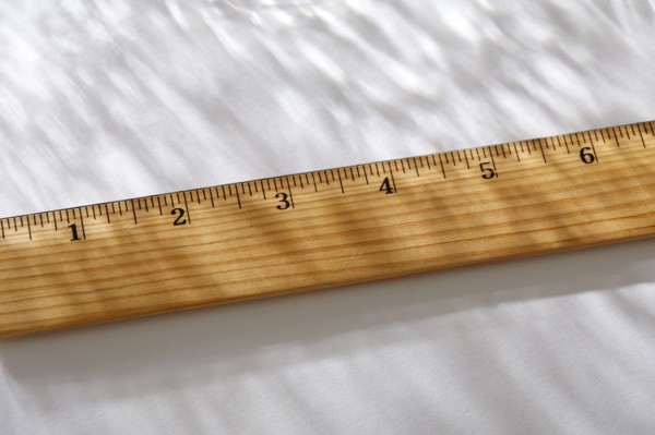 Close-up of wooden ruler on white background in sunlight, New York, NY, USA