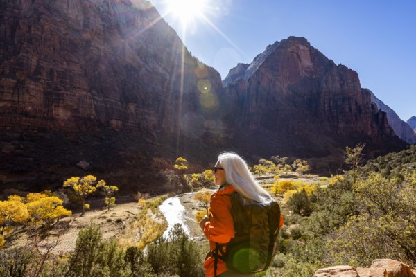 Woman hiking near Angels Landing Trail overlooking Virgin River, , Utah, USA