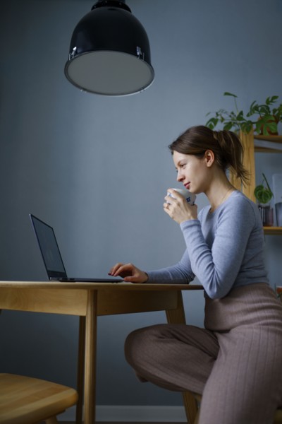 Woman using laptop at home, Omsk, , Russia