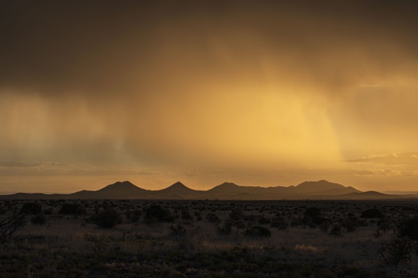 Usa, New Mexico, Santa Fe, Storm and rain over Cerrillos Hills at sunset, Santa Fe, New Mexico, USA