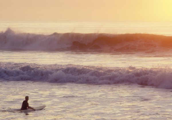 USA, NJ, Lone surfer on Spring Lake at sunrise, Spring Lake, New Jersey, USA
