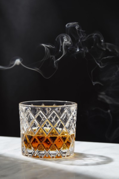Smoke above glass of whiskey, New York, New York, USA