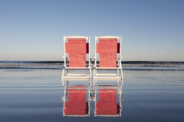 USA, Maine, York, Two beach chairs on wet sand beach, York, Maine, USA
