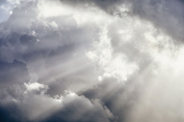 Light rays shining through white cumulus clouds, , St. John, US Virgin Islands
