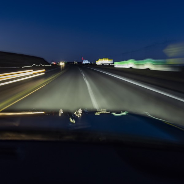 Highway at night seen from moving vehicle, blurred motion, Twin Falls, Idaho, USA