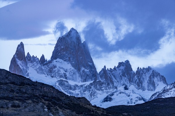 Argentina, Santa Cruz, El Chalten, Clouds above snow covered Mount Fitz Roy at sunset, El Chalten,