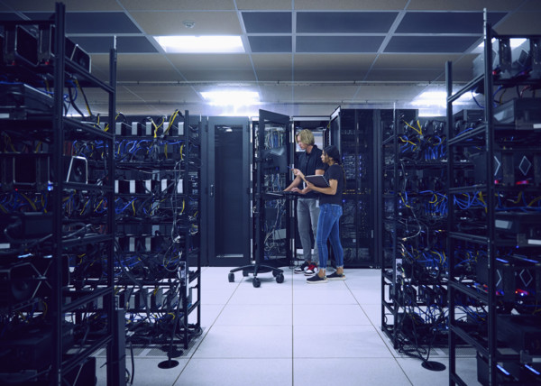 Technicians using computer in server room 
St, George, Utah, USA