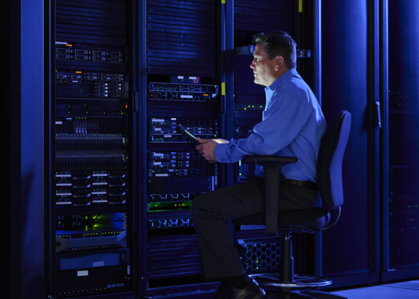 Man using digital tablet in data center
