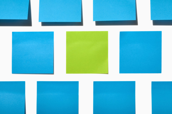 Blue and green post it notes on white background