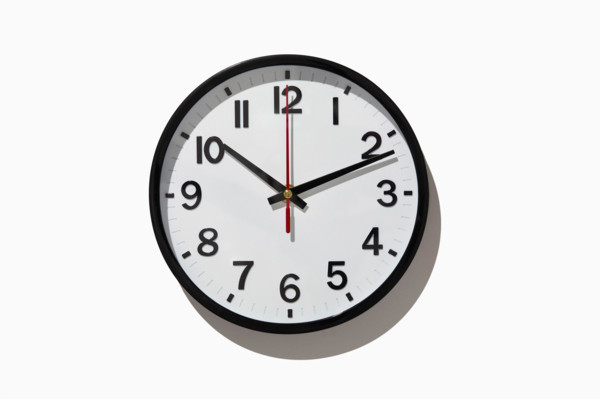 Studio shot of analog wall clock on white background