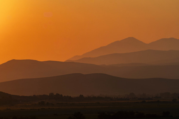USA, Idaho, Bellevue, Silhouettes of hills against orange sky at sunset