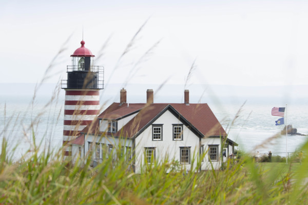 USA, Maine, Lubec, West Quoddy Head Lighthouse with grass in foreground