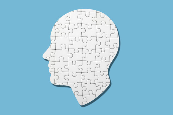 White head shaped puzzle on blue background