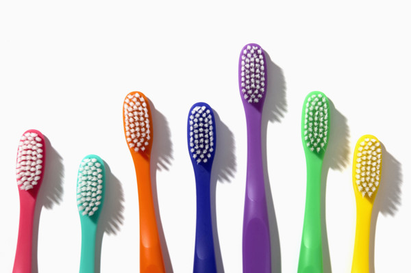Colorful toothbrushes on white background
