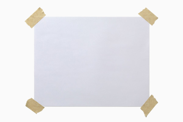 Blank paper taped to white background