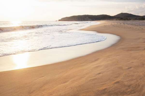 Mexico, Oaxaca State, Puerto Escondido, Costa Chica, Sunlight reflecting in ocean waves on empty