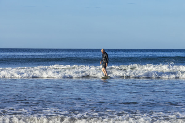 Costa Rica, Guanacaste, Playa Grande, Senior man surfing on sea wave