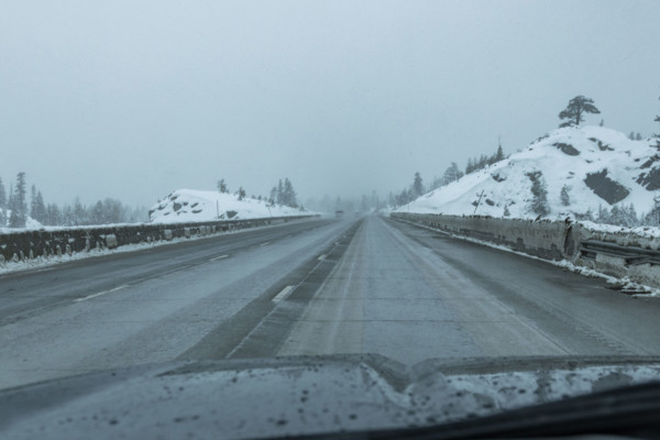 USA, California, Donner Pass, Empty highway seen from car during rain in winter